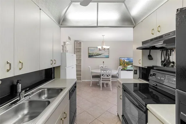a kitchen with granite countertop a sink and a stove top oven