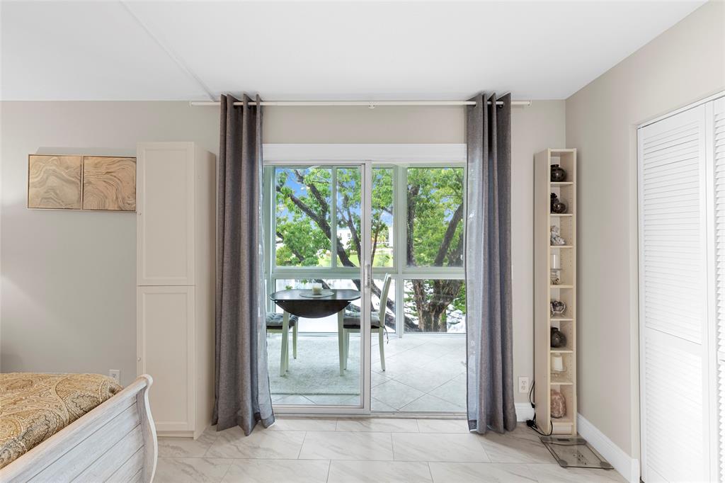 3028 Cambridge B, Unit 3028 Deerfield Beach, FL 33442 - Photo 16 of 49 a living room with furniture and a large window