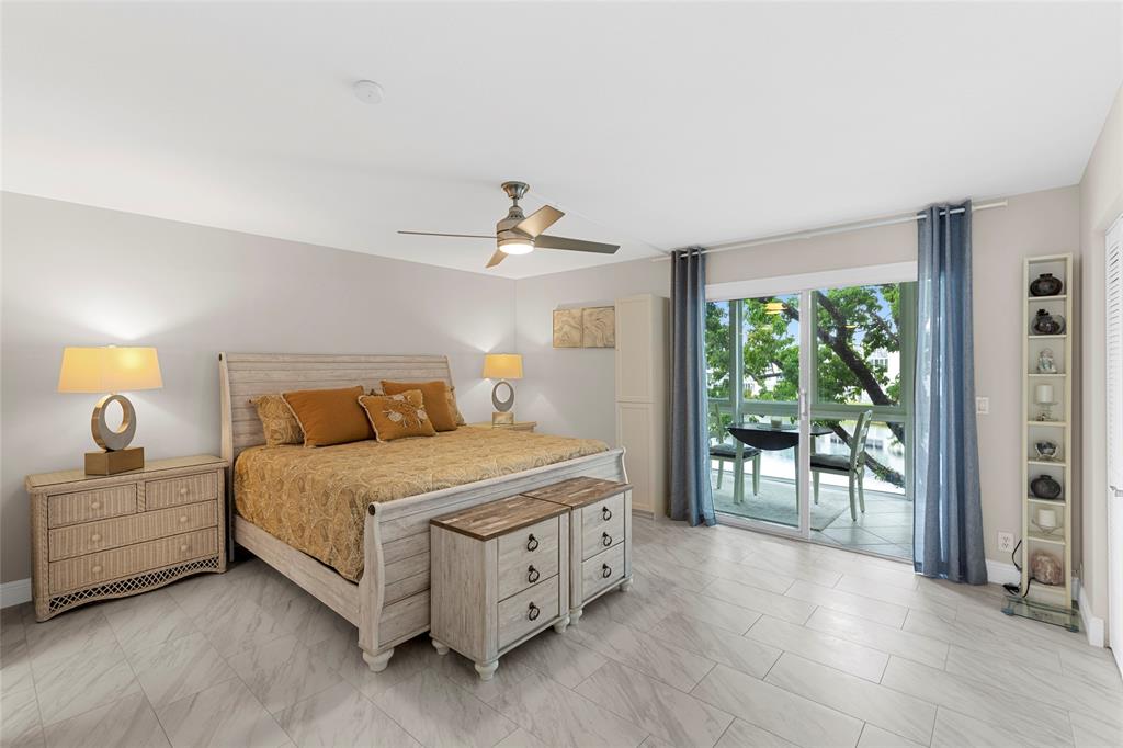 3028 Cambridge B, Unit 3028 Deerfield Beach, FL 33442 - Photo 18 of 49 a spacious bedroom with a bed and a table