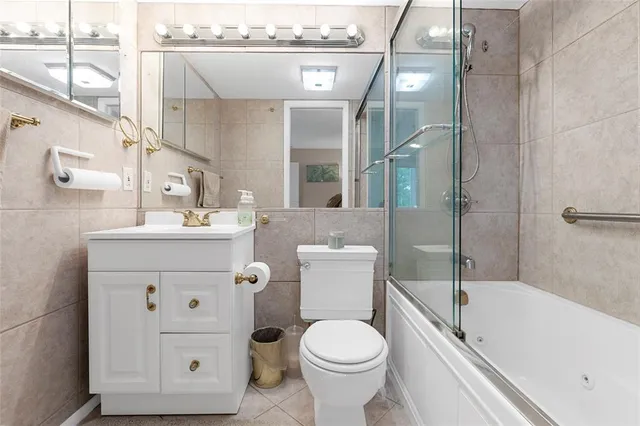 a bathroom with a sink toilet vanity and bathtub