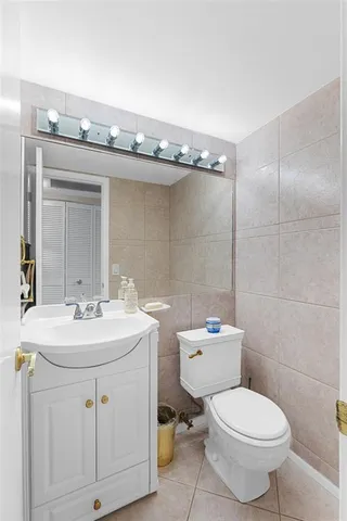 a bathroom with a sink a toilet and mirror