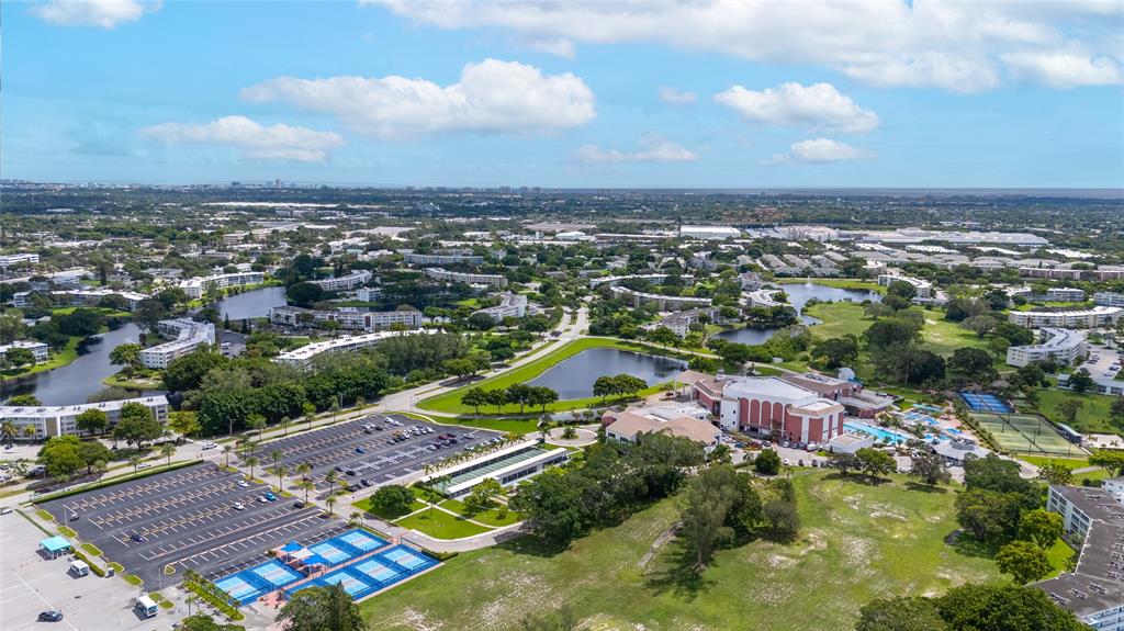 3028 Cambridge B, Unit 3028 Deerfield Beach, FL 33442 - Photo 23 of 49 an aerial view of residential houses with outdoor space and trees