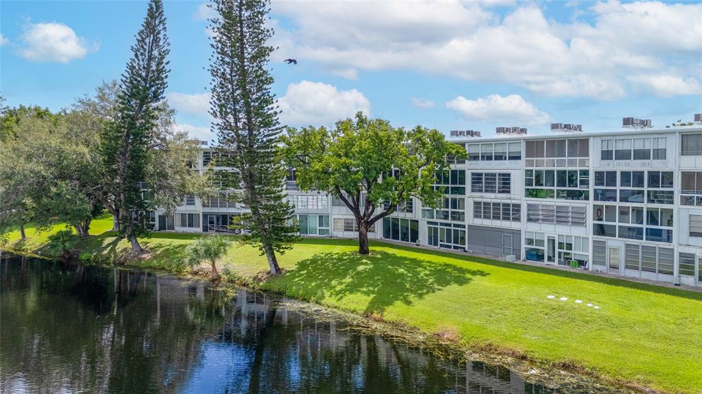 3028 Cambridge B, Unit 3028 Deerfield Beach, FL 33442 - Photo 26 of 49 a view of swimming pool with outdoor seating and plants