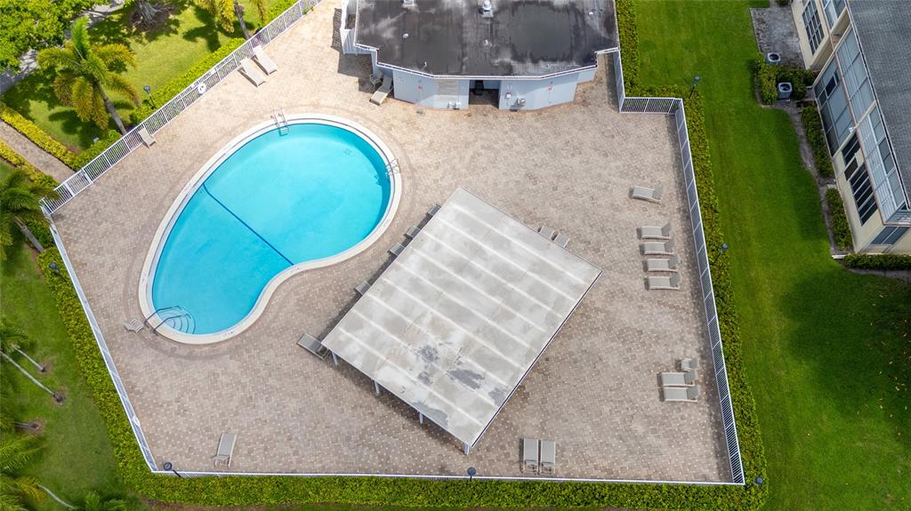 3028 Cambridge B, Unit 3028 Deerfield Beach, FL 33442 - Photo 29 of 49 an aerial view of a house with swimming pool and garden