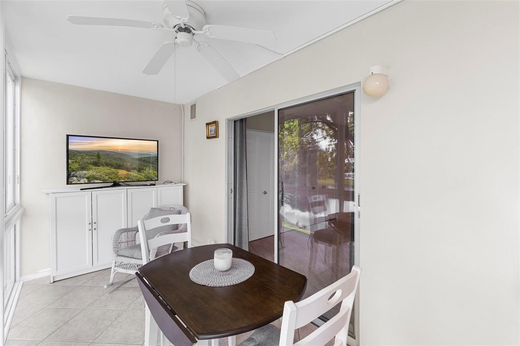 3028 Cambridge B, Unit 3028 Deerfield Beach, FL 33442 - Photo 4 of 49 a living room with furniture and a flat screen tv