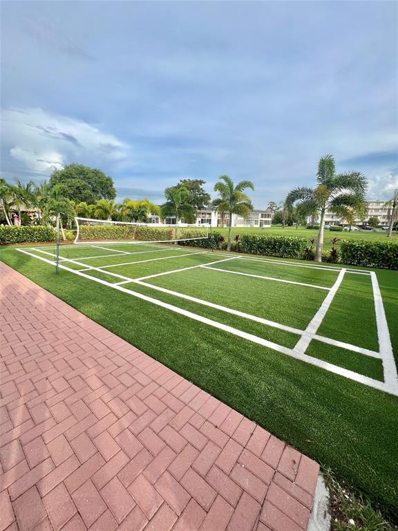 3028 Cambridge B, Unit 3028 Deerfield Beach, FL 33442 - Photo 43 of 49 a view of an outdoor space and tennis court