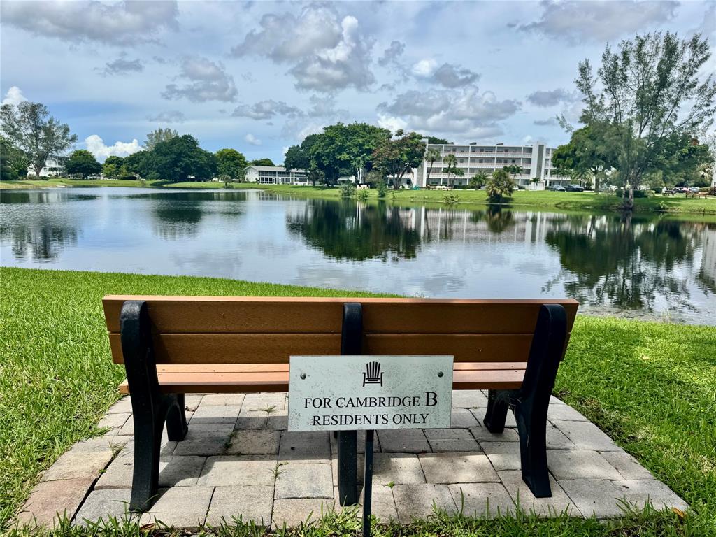 3028 Cambridge B, Unit 3028 Deerfield Beach, FL 33442 - Photo 49 of 49 a view of a lake with a table and chairs
