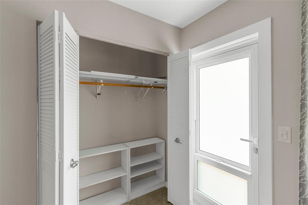 3028 Cambridge B, Unit 3028 Deerfield Beach, FL 33442 - Photo 9 of 49 a view of walk in closet with empty racks