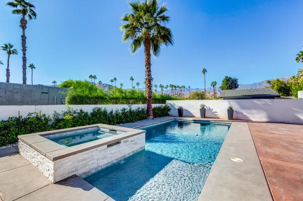 a view of swimming pool with lounge chair