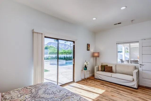 a bedroom with a bed and a large window