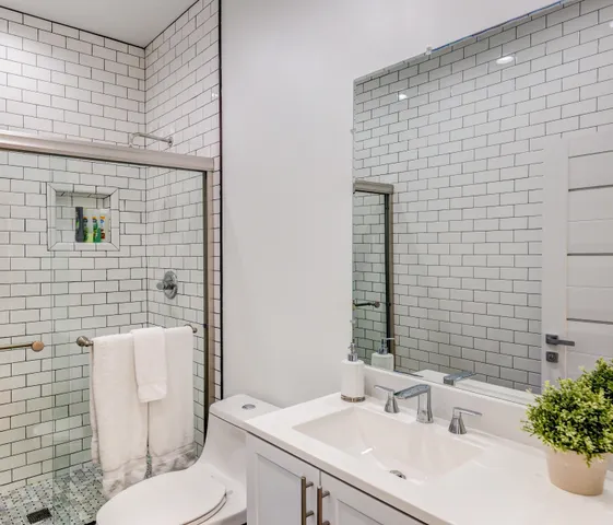 a bathroom with a sink toilet and shower