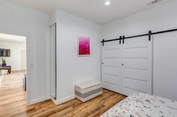 a bedroom with a bed and a dresser