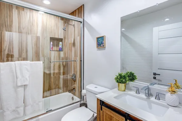 a bathroom with a sink toilet and shower
