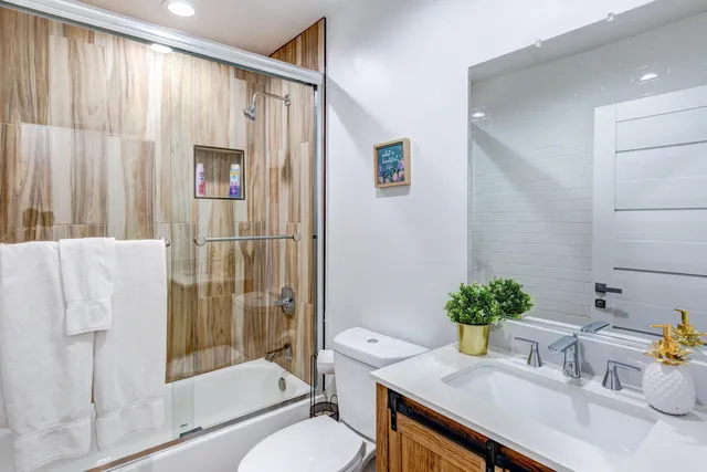 a bathroom with a sink toilet and shower