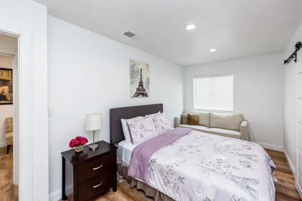 a bedroom with a bed and cabinets
