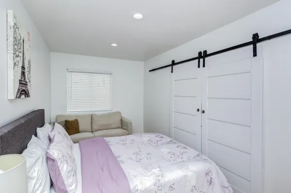 a bedroom with a bed and a dresser
