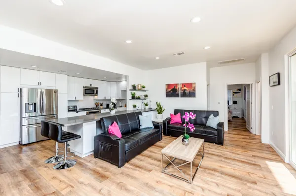 a living room with stainless steel appliances kitchen island granite countertop furniture and a kitchen view