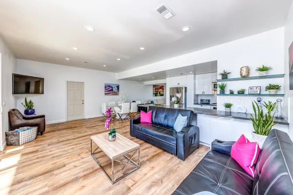 a living room with furniture and wooden floor