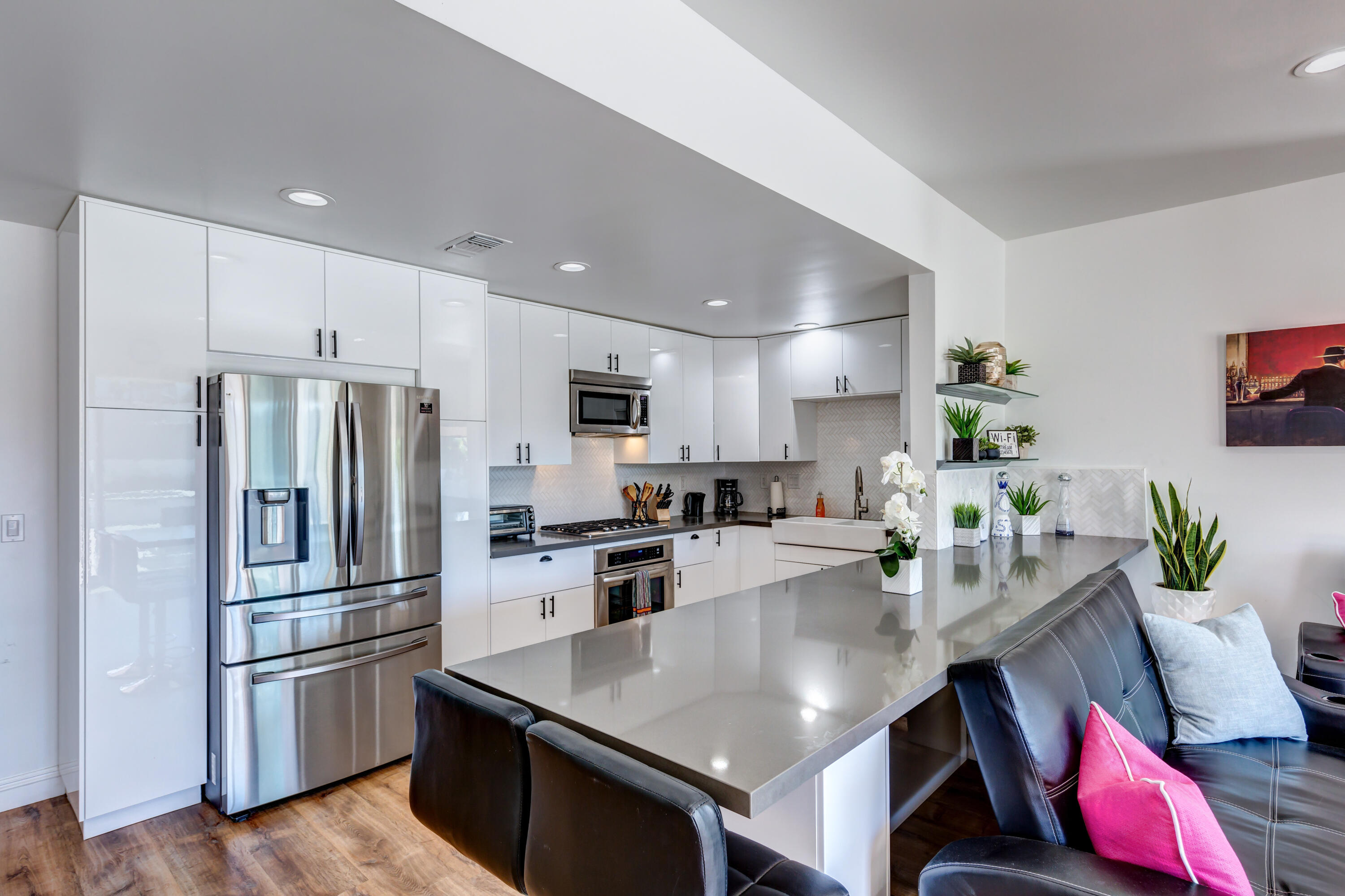 70181 Chappel Road Rancho Mirage, CA 92270 - Photo 31 of 43 a kitchen with stainless steel appliances granite countertop a refrigerator a stove a sink a dining table and chairs