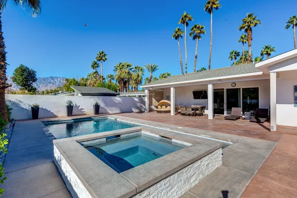 a view of a lake with couches in the patio