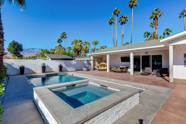 a view of a lake with couches in the patio