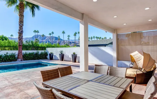 a view of a roof deck with table and chairs potted plants with wooden floor