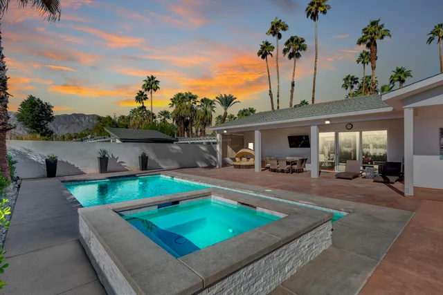 a view of a house with palm trees
