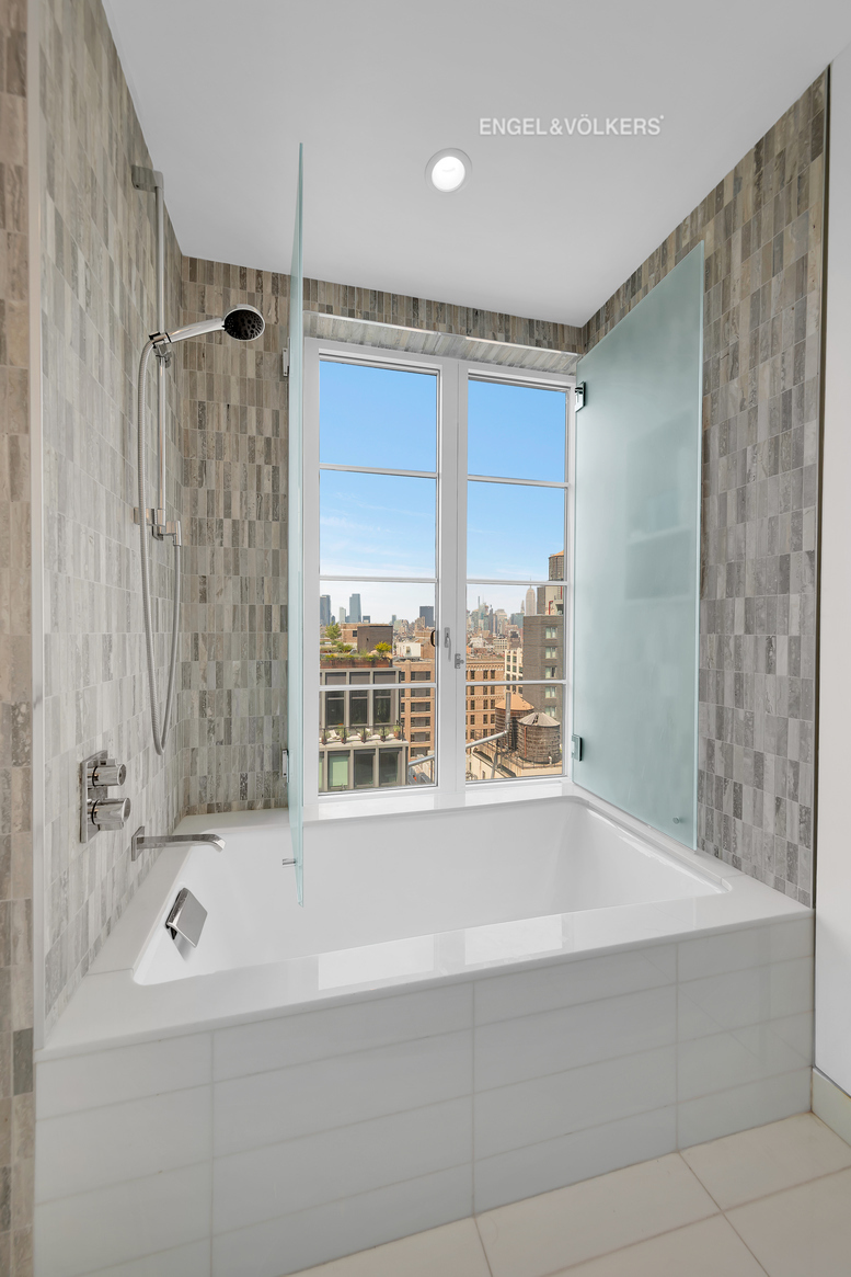70 Charlton Street, Unit 21C Manhattan, NY 10014 - Photo 12 of 22 a bathroom with a bathtub and a shower