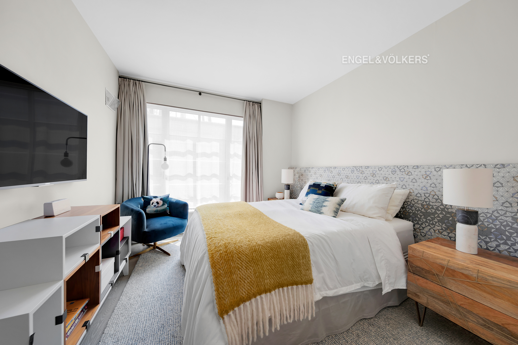 70 Charlton Street, Unit 21C Manhattan, NY 10014 - Photo 13 of 22 a bedroom with a bed and a flat screen tv