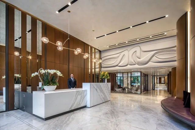 a living room with furniture and a floor to ceiling window