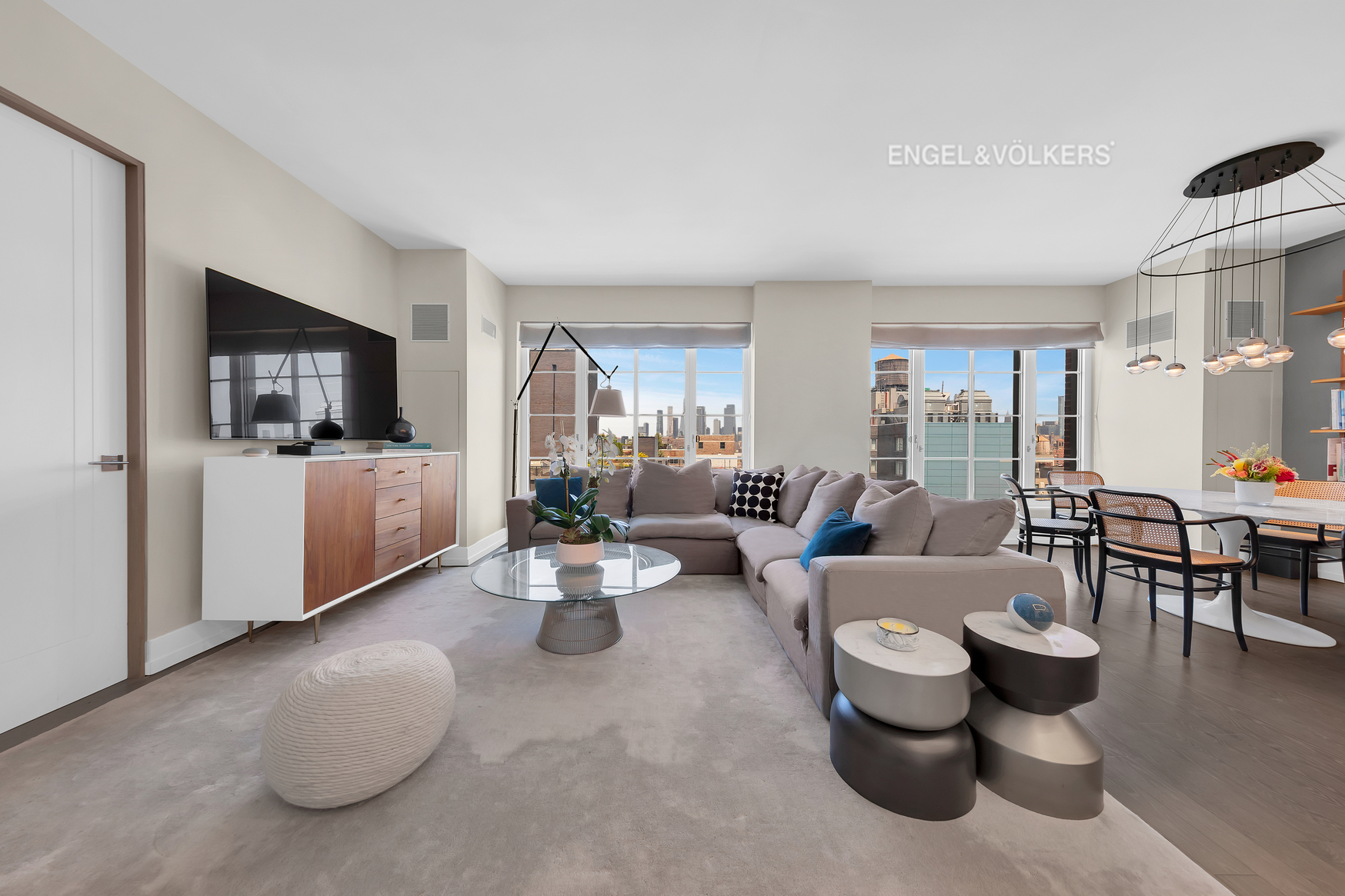 70 Charlton Street, Unit 21C Manhattan, NY 10014 - Photo 2 of 22 a living room with furniture and a flat screen tv