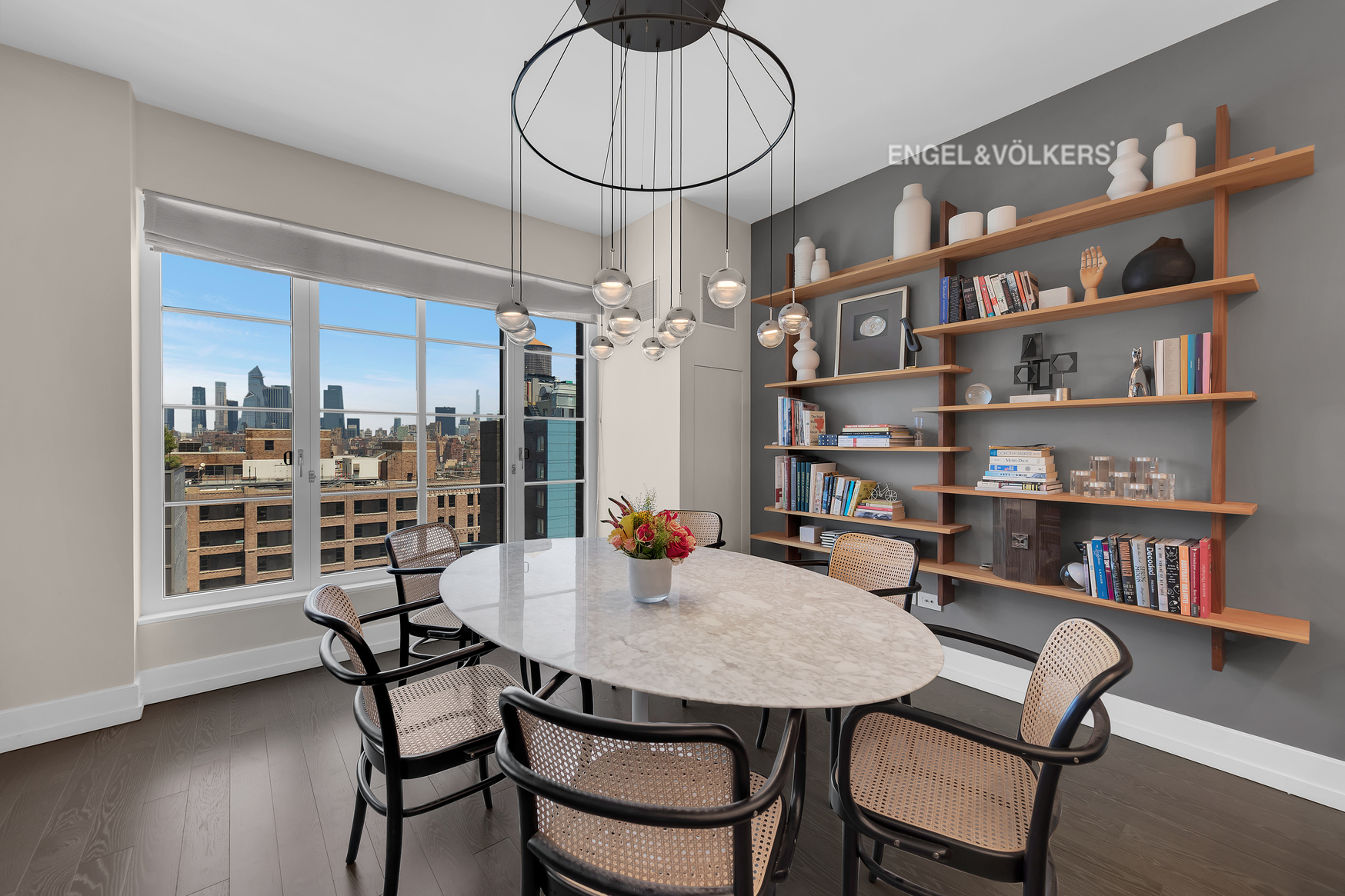 70 Charlton Street, Unit 21C Manhattan, NY 10014 - Photo 3 of 22 a view of a dining room with furniture and a book shelf