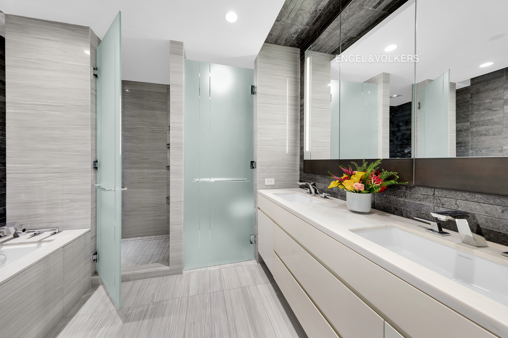 70 Charlton Street, Unit 21C Manhattan, NY 10014 - Photo 8 of 22 a bathroom with a tub sink and mirror