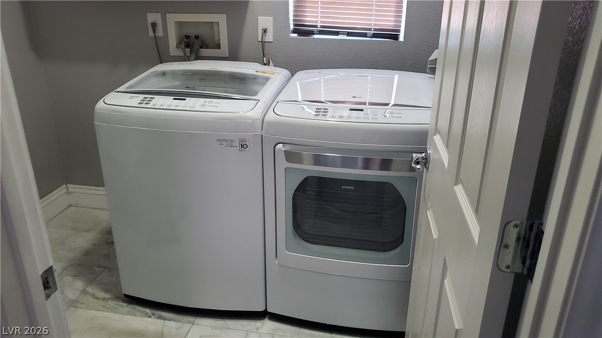 7903 Dell Ridge Avenue Las Vegas, NV 89179 - Photo 13 of 20 A well-appointed laundry area offers practical solutions for daily chores.