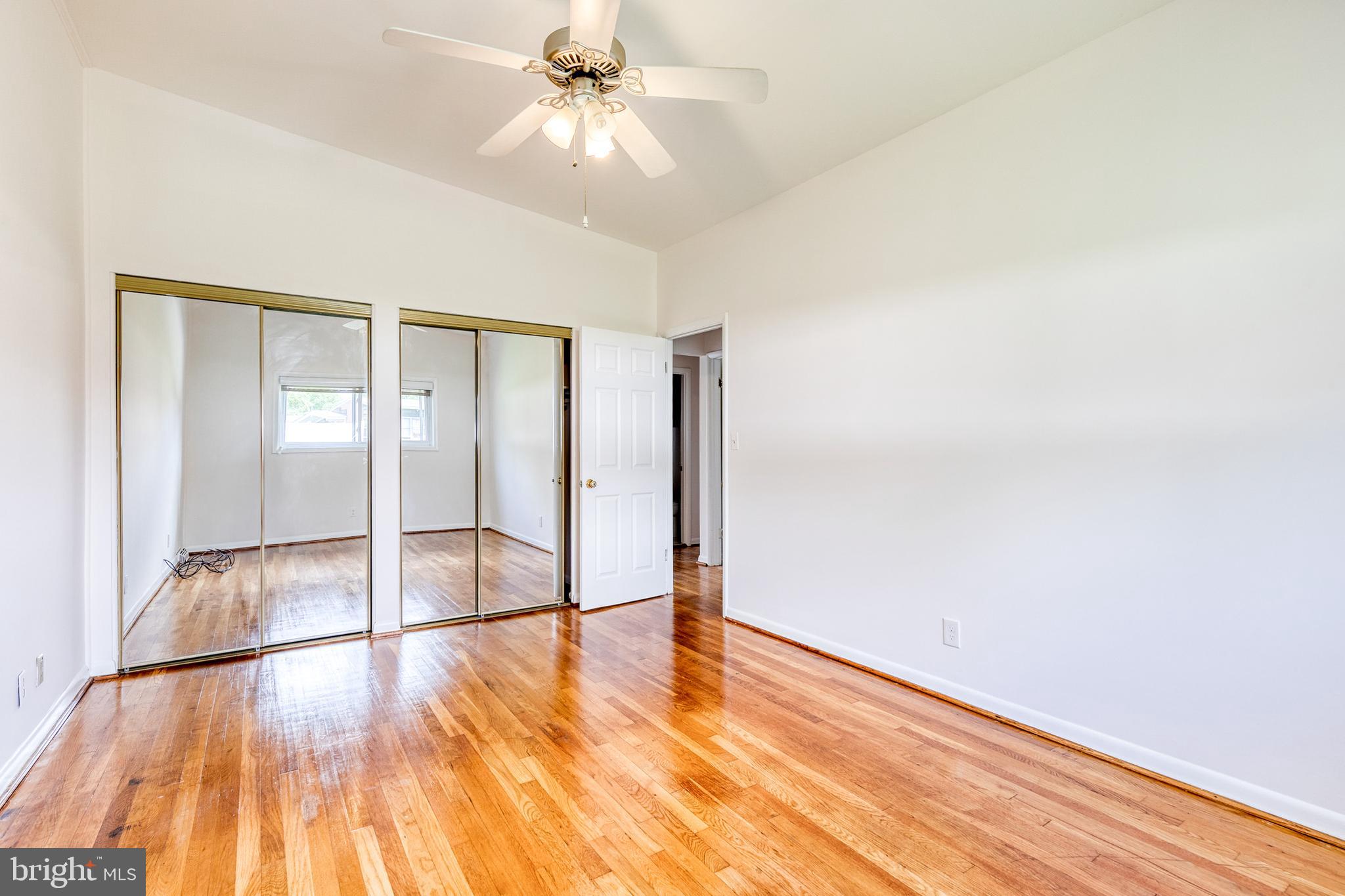 6653 Chippewa Drive Baltimore, MD 21209 - Photo 14 of 24 a view of empty room with wooden floor and fan