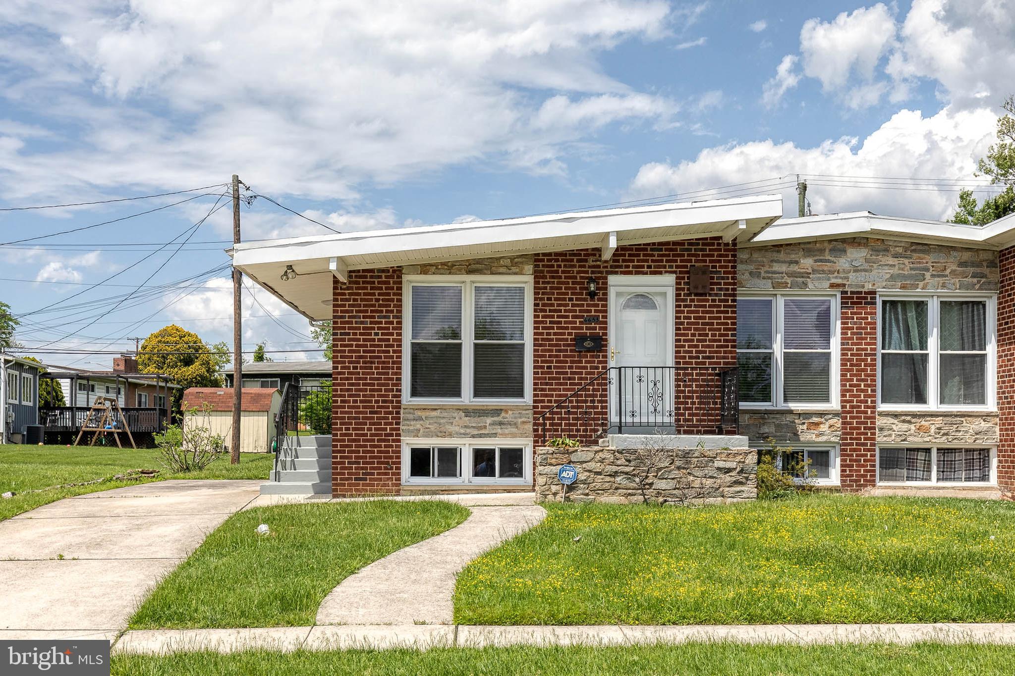 6653 Chippewa Drive Baltimore, MD 21209 - Photo 2 of 24 a front view of a house with a yard