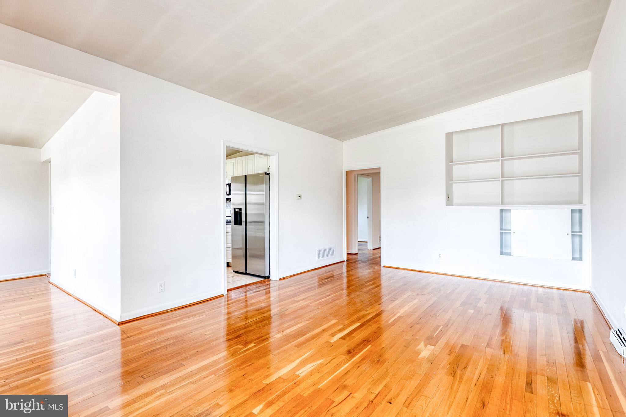 6653 Chippewa Drive Baltimore, MD 21209 - Photo 4 of 24 an empty room with wooden floor and windows