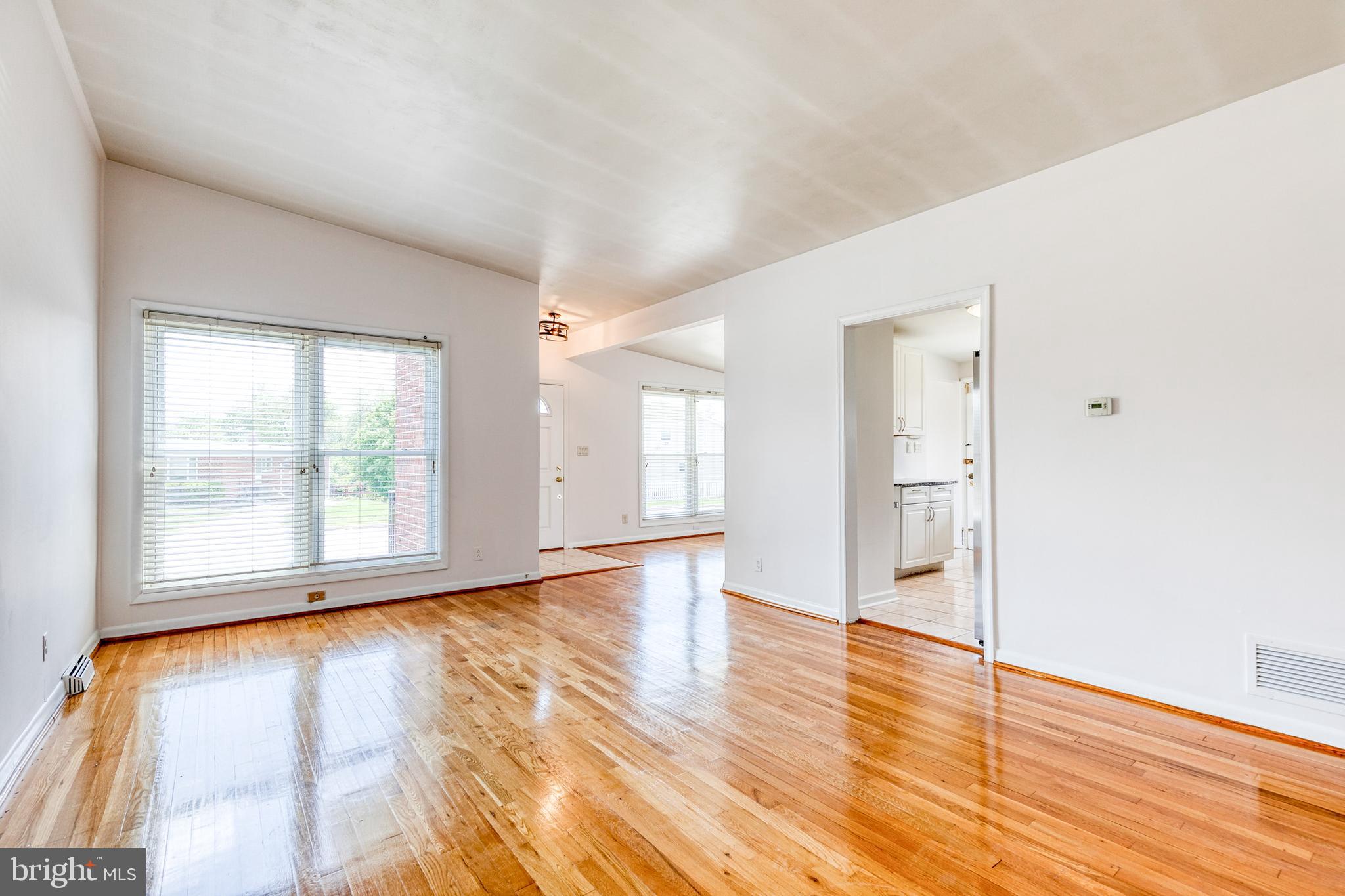 6653 Chippewa Drive Baltimore, MD 21209 - Photo 5 of 24 a view of empty room with wooden floor and fan