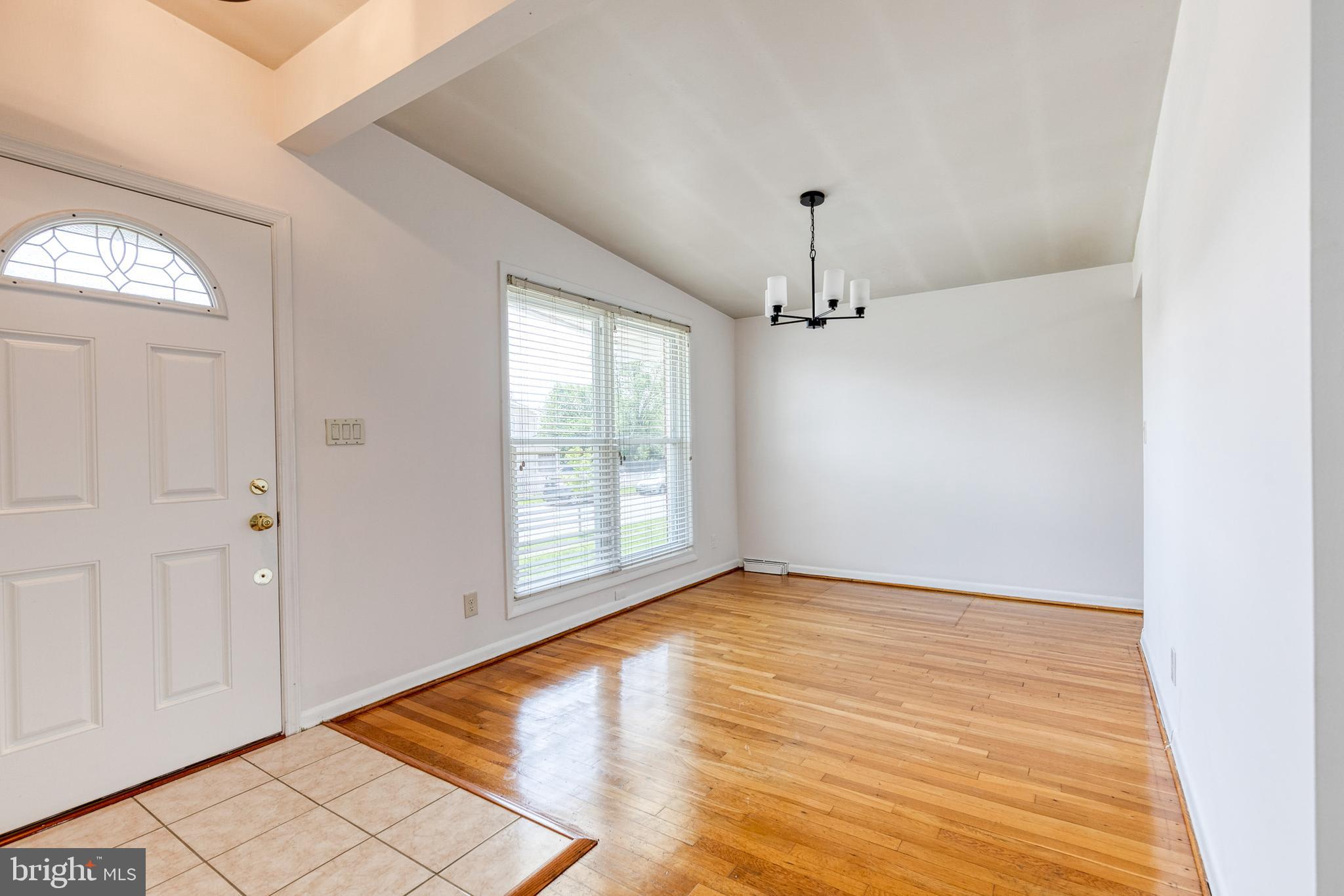 6653 Chippewa Drive Baltimore, MD 21209 - Photo 6 of 24 wooden floor in an empty room with a window