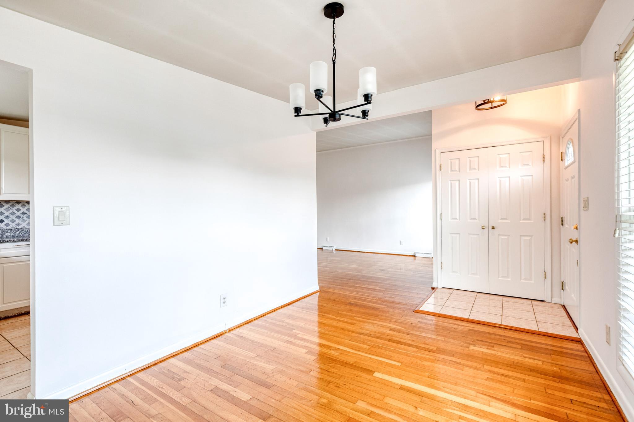 6653 Chippewa Drive Baltimore, MD 21209 - Photo 8 of 24 a view of a hallway with wooden floor and staircase