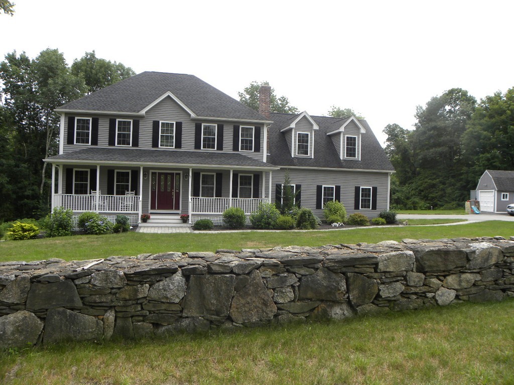 57 McIntyre Road Charlton, MA 01507 - Photo 1 of 30 a front view of a house with a yard table and chairs