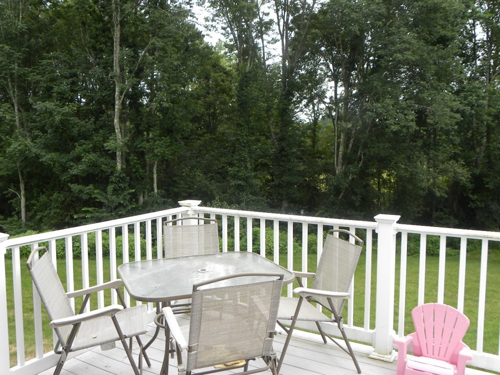 57 McIntyre Road Charlton, MA 01507 - Photo 16 of 30 a view of a chair and table on the deck