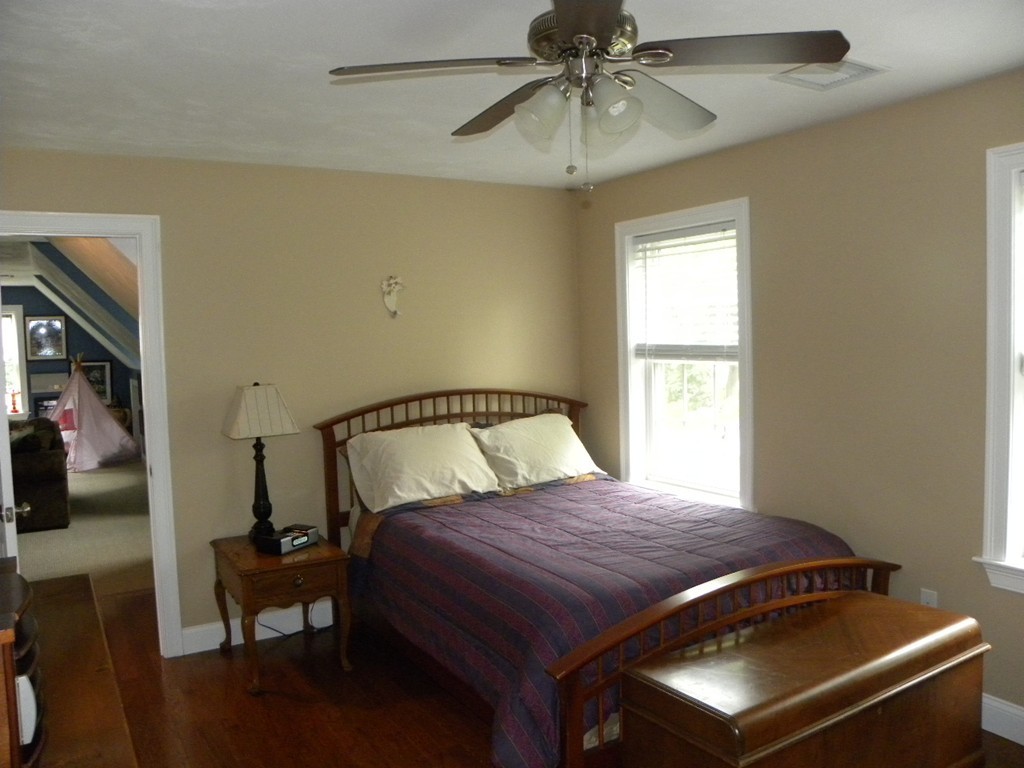 57 McIntyre Road Charlton, MA 01507 - Photo 17 of 30 a bedroom with a bed and a chandelier