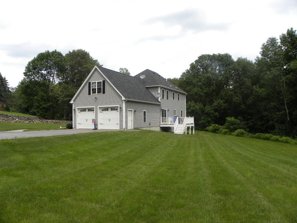 57 McIntyre Road Charlton, MA 01507 - Photo 2 of 30 a view of a house with backyard and garden