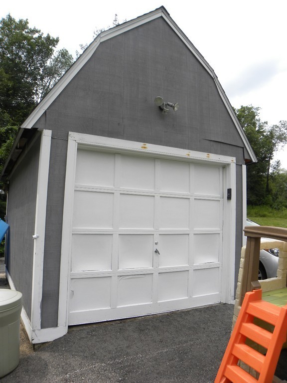 57 McIntyre Road Charlton, MA 01507 - Photo 24 of 30 a backyard of a house with wooden fence and large windows