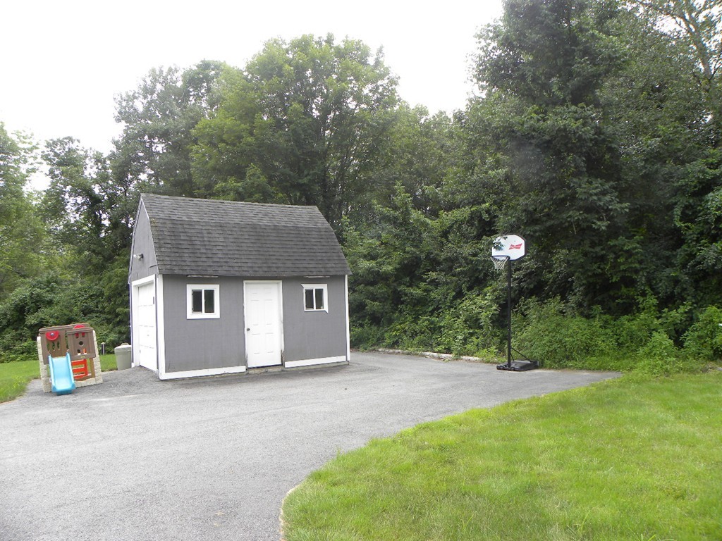 57 McIntyre Road Charlton, MA 01507 - Photo 26 of 30 a front view of a house with a yard and garage