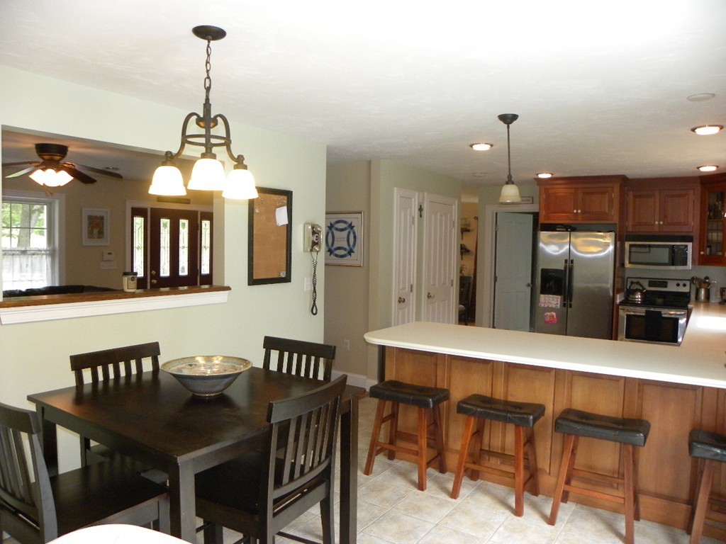57 McIntyre Road Charlton, MA 01507 - Photo 3 of 30 a dining room with a table chairs and a kitchen view