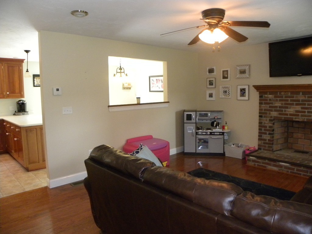 57 McIntyre Road Charlton, MA 01507 - Photo 5 of 30 a living room with furniture a flat screen tv and a fireplace