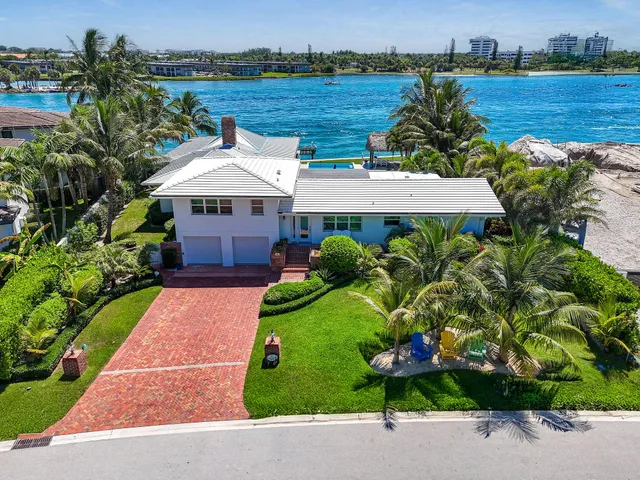 an aerial view of a house with a yard and garden