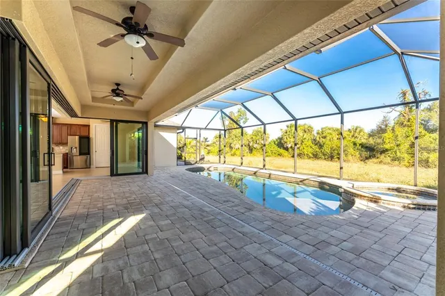 a large kitchen with stainless steel appliances kitchen island granite countertop a refrigerator a stove a oven and a sink with large window